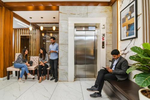 a group of people sitting in a lobby at FabHotel Sonali Golden Palace - Nr Bhubaneswar Railway Station in Bhubaneshwar