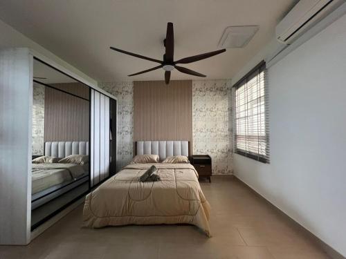 a bedroom with a bed and a ceiling fan at Sky28 - Sireh Residence in Kota Bharu