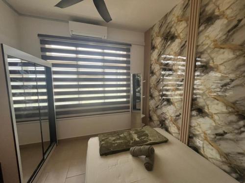 a bathroom with a large stone wall and a window at Sky28 - Sireh Residence in Kota Bharu