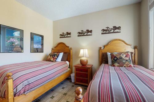 a bedroom with two beds and a night stand at Sun Vail 24B in Vail