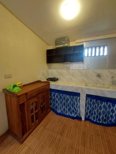 a kitchen with a blue and white counter top at B&R Hostel in Puerto Princesa City