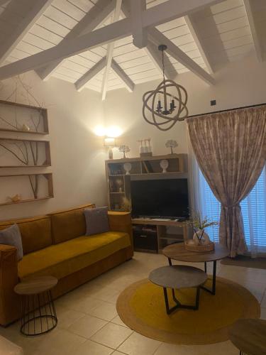 a living room with a couch and a tv at Elais House Methoni in Methoni