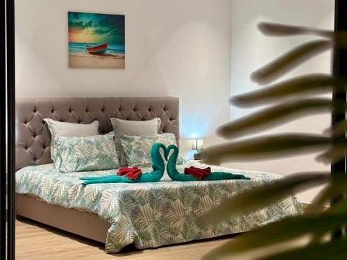 a bedroom with a bed with aopus on it at Zolikaz in Grand-Baie