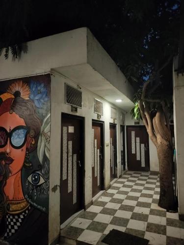 a building with a painting on the side of it at Moondance Hostel & Garden Restaurant in Pushkar