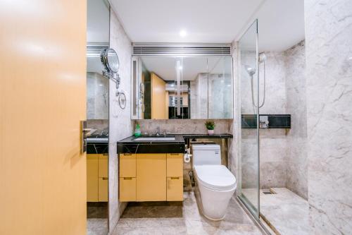 a bathroom with a toilet and a shower at Argyle WAIFIDEN Baolidian Hotel -Free shuttle bus during Canton Fair in Guangzhou