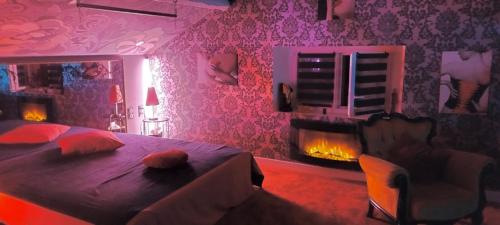 a bedroom with a bed and a fire place at Love-Room Chic&Glam' in Saint-Vincent-de-Paul