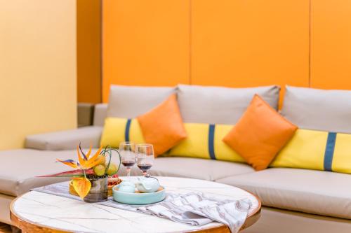 a living room with a couch and a table with wine glasses at Argyle WAIFIDEN Baolidian Hotel -Free shuttle bus during Canton Fair in Guangzhou