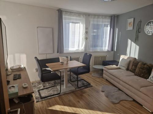 a living room with a table and a couch at Alpenglück Apartment in Bach