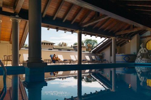 a pool at a resort with chairs and a swimming pool at Il Castello Di San Gaudenzio in Cervesina