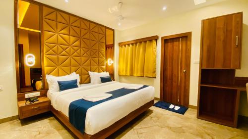 a bedroom with a large bed in a room at The Velar Hotel, Vijay Nagar in Indore