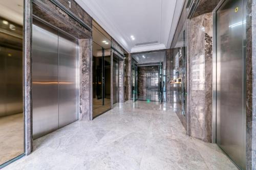 a hallway with glass doors in a building at Argyle WAIFIDEN Baolidian Hotel -Free shuttle bus during Canton Fair in Guangzhou