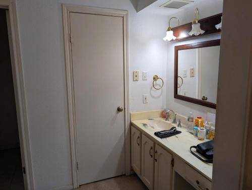 a bathroom with a sink and a mirror at Cozy Townhome in Missouri City