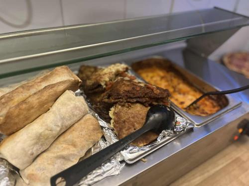 a display case with different types of food in at Greg&Tom Party Hostel in Kraków