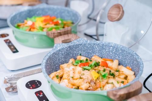 two bowls of food sitting on a table at Argyle WAIFIDEN Baolidian Hotel -Free shuttle bus during Canton Fair in Guangzhou