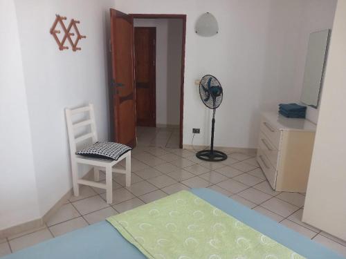 a living room with a chair and a fan at Vilas Praia de Chaves Deluxe house sol y mar in Rabil