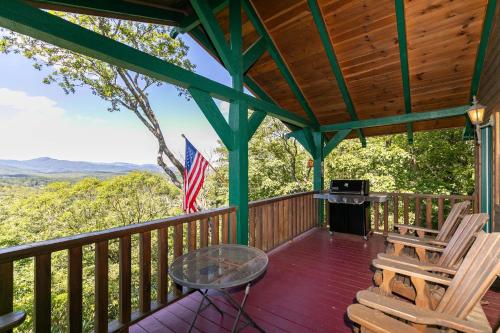 a porch with two chairs and a table and a grill at On Any Sunday in Blowing Rock