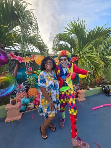 a woman standing next to a man dressed in a clown costume at Eve's Rockaway Villa in Alligator Pond Village