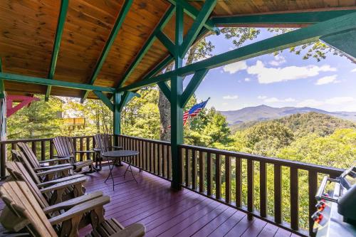 a porch with rocking chairs and an american flag at On Any Sunday in Blowing Rock