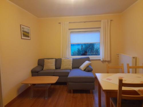 a living room with a couch and a table at Ferienhof Rüßmann in Lennestadt