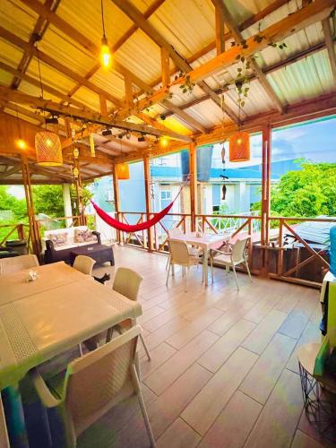 a large room with tables and chairs on a patio at Colorful Garden House in Providencia