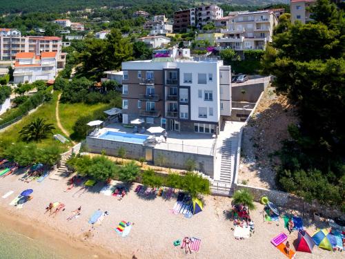 an aerial view of a beach with chairs and umbrellas at Villa Veronika in Omiš