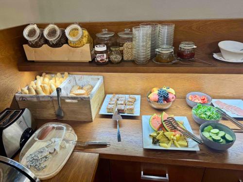 a table with different types of food on it at Resort-Restaurant Stilec in Kamenný Újezd