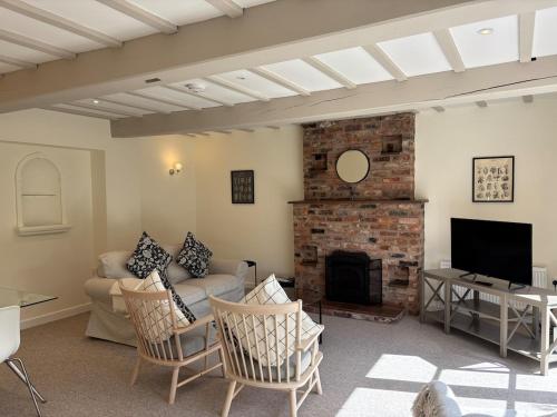 a living room with a couch and a fireplace at The Barn in Brereton cum Smethwick