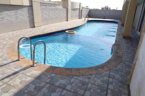 a swimming pool on top of a building at Moments in Jeddah
