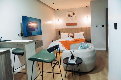 a bedroom with a bed and a table and a chair at Luxury Studio Retreat in wuse2 in Abuja