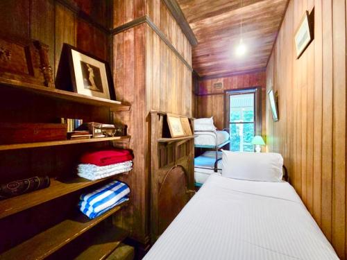 a small room with two beds and shelves at Rostherne House in Blackheath