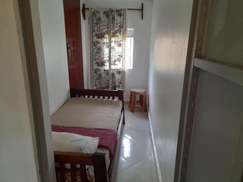 Ένα ή περισσότερα κρεβάτια σε δωμάτιο στο Maasai Villa Backpackers Home