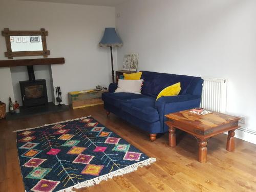 a living room with a blue couch and a coffee table at Institution Road in Elgin