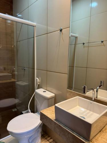 a bathroom with a toilet and a sink and a shower at Chalé do Comendador,Praia do Maceió-Camocim Ce in Camocim