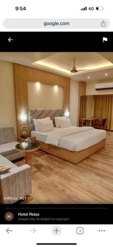 a bedroom with a large bed and a living room at Hotel Relax in Jāmb