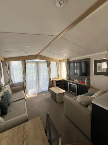 a large living room with couches and a tv at Luxury 3 bed swift home in Hastings