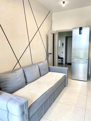 a living room with a couch and a refrigerator at Апартаменти Люкс, Центр, ЖК Яровиця,Паркомісце in Luts'k