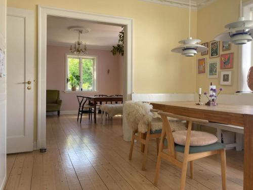 a kitchen and dining room with a table and chairs at Lovely villa for families and business traveler's in Aalborg