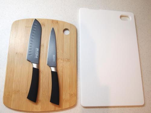 a knife on a cutting board next to a cell phone at Minpaku 123 - Vacation STAY 15837 in Nasushiobara