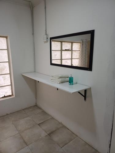 a white room with a shelf and a mirror at 19 on Smit in Piet Retief