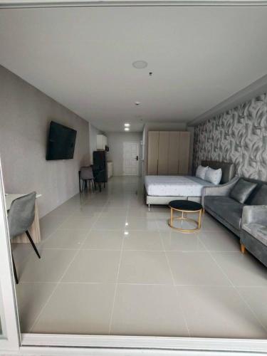 a large room with a bed and a couch at View Talay6 by Blue Ocean Suite in Pattaya Central