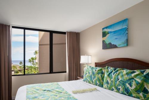 a bedroom with a bed and a large window at Kaanapali Shores 527 · KS 527 2Bedroom w Ocean Views in BeachFro in Kahana