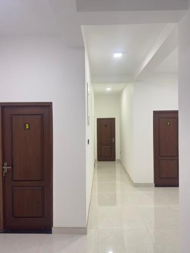 a hallway with two doors in a building at Lotus Manuvala - Negombo in Kochchikade