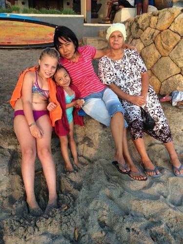 a group of people sitting on the beach at Jeges Homestay in Senggigi 