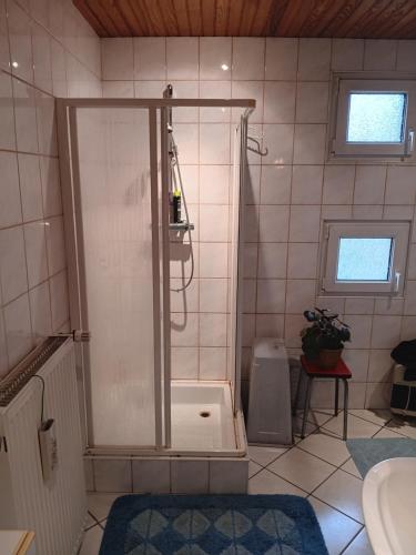 a shower with a glass door in a bathroom at Chez mamie in Sarralbe