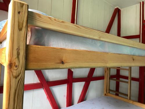 a wooden bunk bed in a small room at Casas Salomão in Santo António