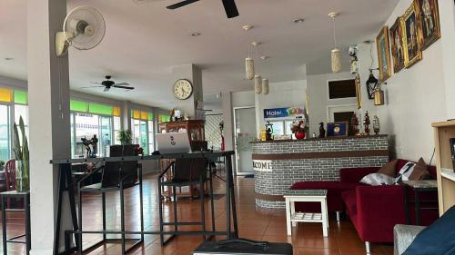 a living room with a couch and a table with a laptop at AT home hotel in Hua Hin