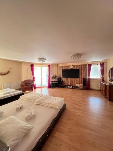 a large bedroom with a bed with two towels on it at Sabina house in Vestec
