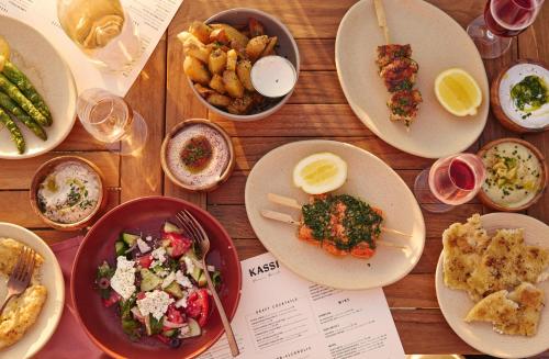 a wooden table with plates of food on it at Hotel Erwin Venice Beach in Los Angeles