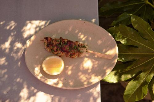 a white plate with a piece of food and a spoon at Hotel Erwin Venice Beach in Los Angeles