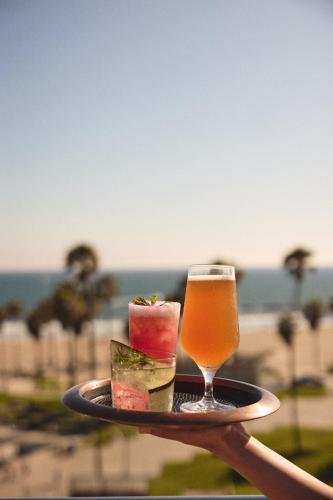 a person holding a tray with a drink at Hotel Erwin Venice Beach in Los Angeles